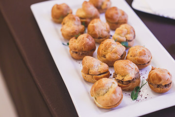 Beautifully decorated catering banquet table with different food snacks and appetizers on corporate christmas birthday party event or wedding celebration
