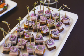 Beautifully decorated catering banquet table with different food snacks and appetizers on corporate christmas birthday party event or wedding celebration
