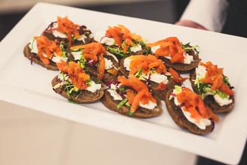 Beautifully decorated catering banquet table with different food snacks and appetizers on corporate christmas birthday party event or wedding celebration
