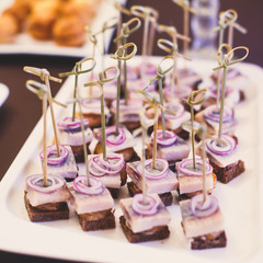 Beautifully decorated catering banquet table with different food snacks and appetizers on corporate christmas birthday party event or wedding celebration
