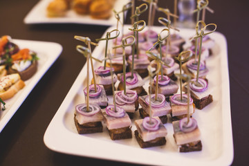 Beautifully decorated catering banquet table with different food snacks and appetizers on corporate christmas birthday party event or wedding celebration

