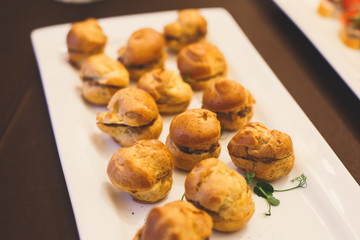 Beautifully decorated catering banquet table with different food snacks and appetizers on corporate christmas birthday party event or wedding celebration
