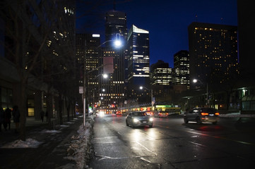 Fototapeta na wymiar Toronto downtown street view with cars headlamps reflection on wet asphalt