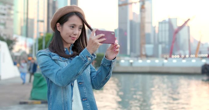 Young Woman using mobile phone to take photo