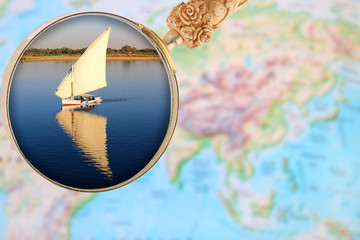 Magnigying glass over Egypt showing a fellucca sailboat Egypt, Africa