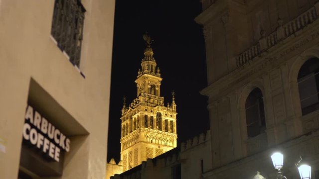 Giralda seen behind a building at night