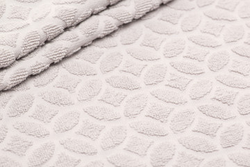 beige bath towel with folds. textured fabric background