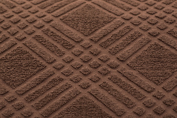 brown bath towel in a cage. textured fabric background
