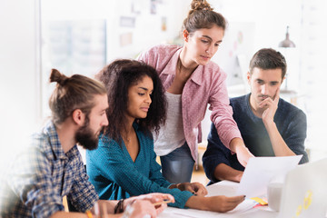 Fototapeta premium At office. A young multiethnic team at work.