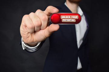 A businessman shows an inscription:UNLOCK YOUR POTENTIAL