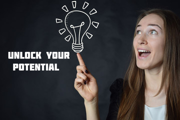 A businessman shows an inscription:UNLOCK YOUR POTENTIAL