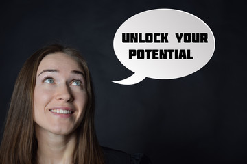 In the hands of a businessman, a neon circle with the inscription:UNLOCK YOUR POTENTIAL