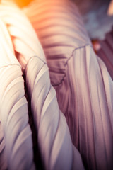 Gradient striped satin fabric texture in purple mauve and orange golden lighting colours. Toned, sunlight effect © Iuliia