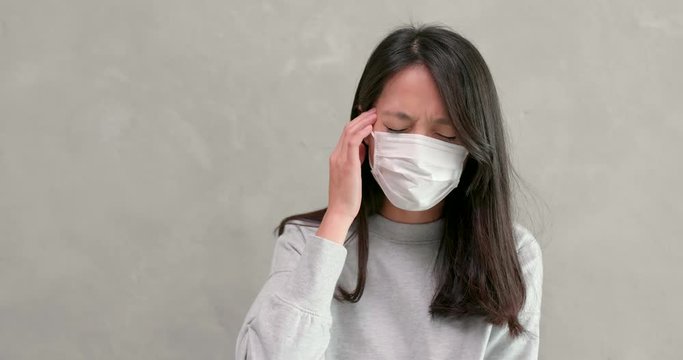 Woman wearing mask and feeling sick