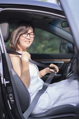 asian woman fasten car seat belt before take a driving