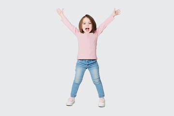 Cute girl raise hands up on a white background.