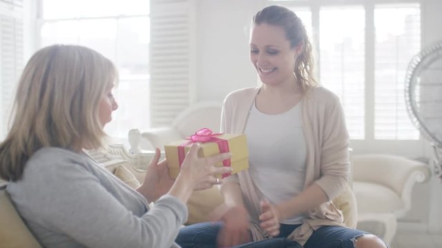 Young woman surprises her mother with a gift