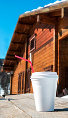 Fototapeta na wymiar cup with hot drink on the table on the ski resort