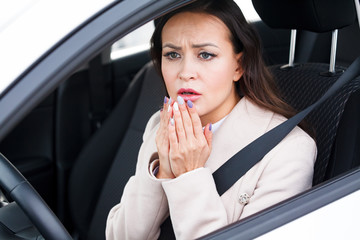 Closeup shot of stressed young woman driver in a car