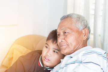 Father and Dad Day concept : Asian retired Grandfather and nephew or grandson, young boy hugging...