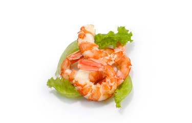 Big cooked peeled shrimps on lettuce leaves on white background
