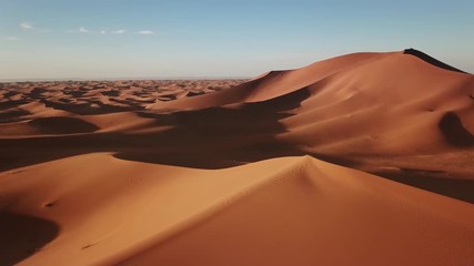 Aerial view on big sand dunes in Sahara desert at sunrise, Africa, 4k
 - Powered by Adobe