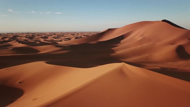 Aerial view on big sand dunes in Sahara desert at sunrise, Africa, 4k

