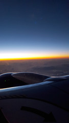 Fototapeta na wymiar Sunrise light over the clouds from Airplane Wing