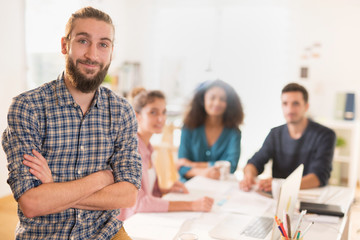 At office. Portrait of a young man looking at the camera. In the