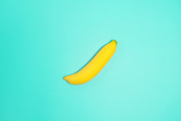 Single banana on color background., From top view.