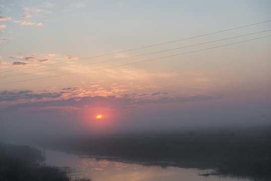 Beautiful foggy sunrise in Ukraine. Fog on the field. Untouched nature © mykola