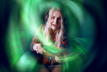 girl gamer in headphones and with a joystick in her hands playing network games preparing to participate in international competitions in e-sports © Mikhaylovskiy 