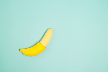 Single banana on color background., From top view.