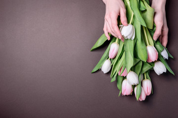 florist collects a spring bouquet of tender tulips