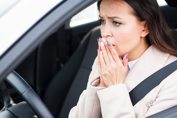 Closeup shot of stressed young woman driver in a car