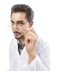 A fun shot of a confident person in a lab coat looking through his glasses with acknowledgment and...