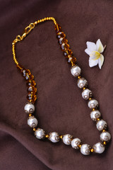 Pearl beads on a suede background