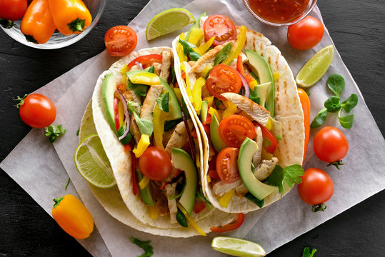 Taco with chicken meat and vegetables.