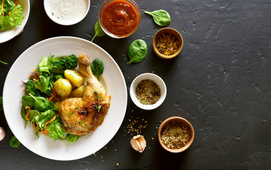 Grilled chicken leg with potato and green salad