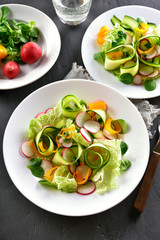 Vegetable salad from zucchini, radish, greens