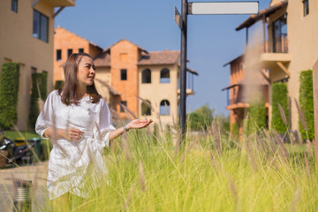 fashion asian girl in outdoor photo of gorgeous woman with dark hair in elegant white dress