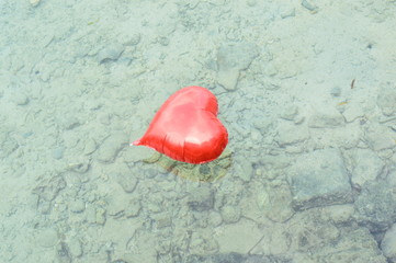 red Love balloon float at sea