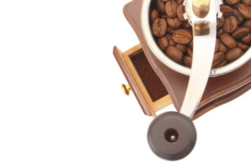 Vintage manual coffee grinder with roasted coffee beans isolated on white background