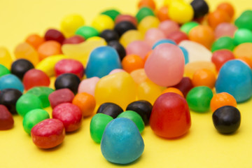 colorful candies on yellow background