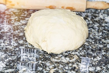 dough ball of eggs and flour with rolling pin
