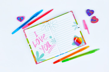 Notebook with stationery on a white table