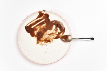 Top view of dirty plate with ice cream stains and fat