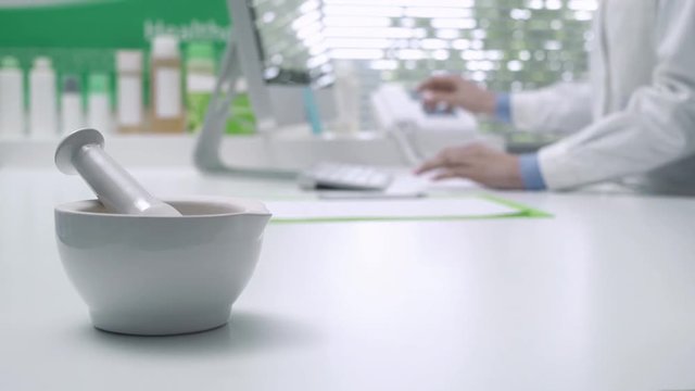 Professional pharmacist working with a computer