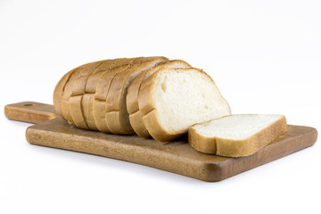 Fresh baked bread on wooden cutting board. Bun slice on isolated white background.