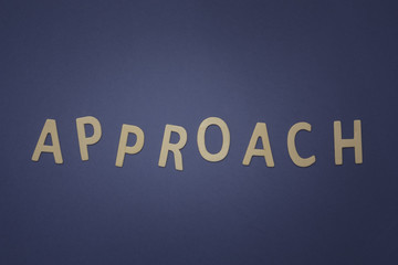 Approach written with wooden letters on a blue background